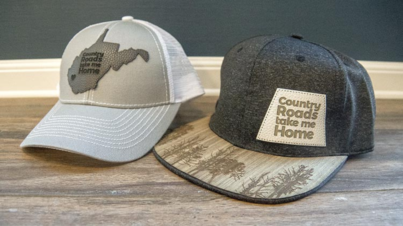 Custom stitched leather logo patch attached to wide-brim hat